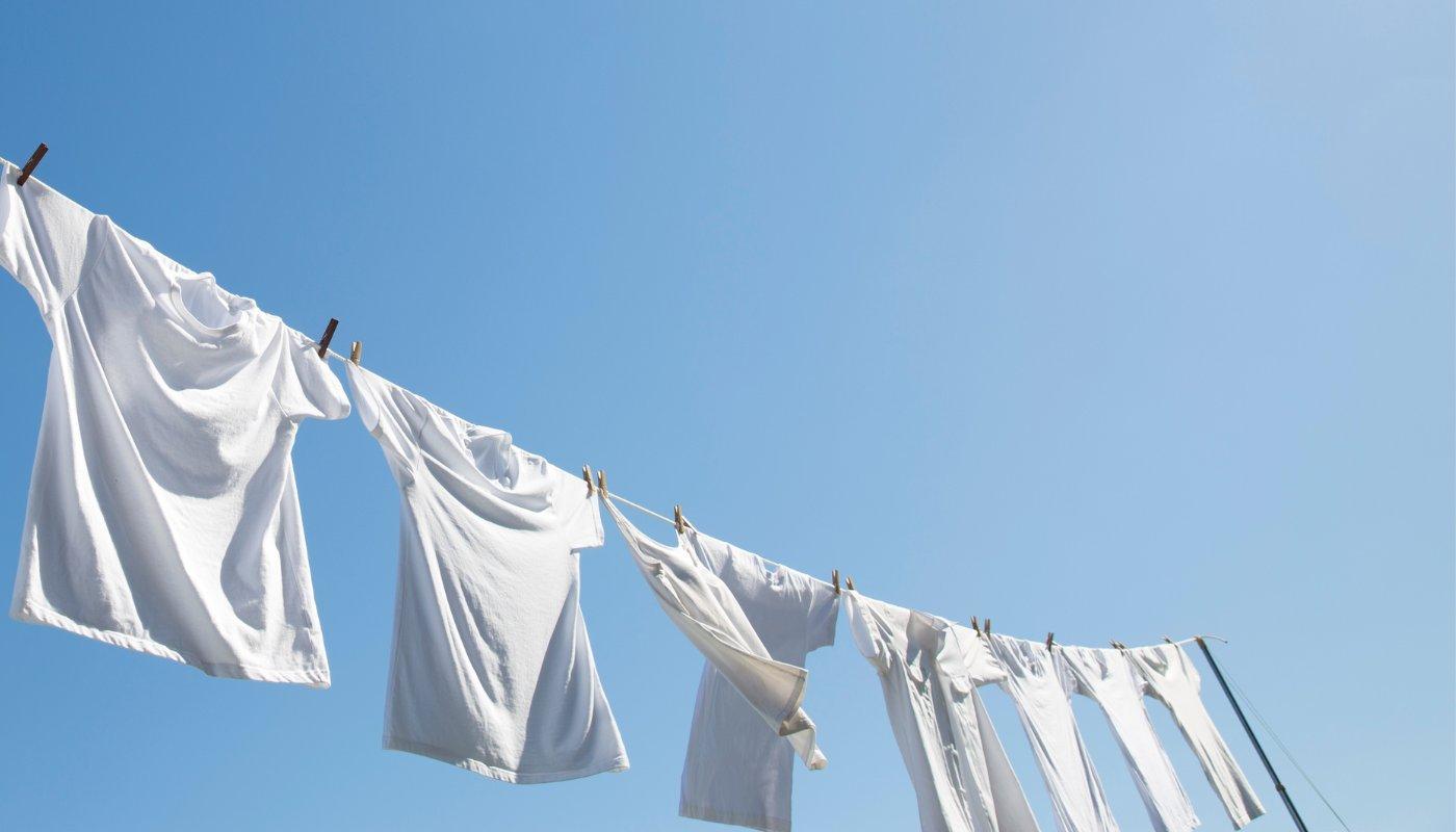 white t-shirts hanging on a clothes line